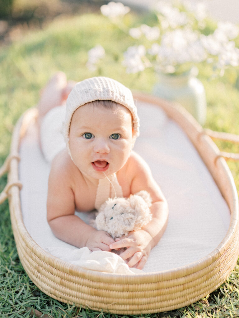 Baby laying in a basket at sunset session Cynthia Knapp Photography