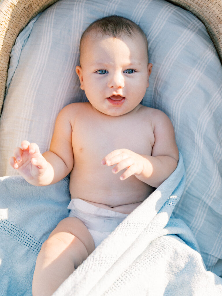 Baby laying in a basket at sunset