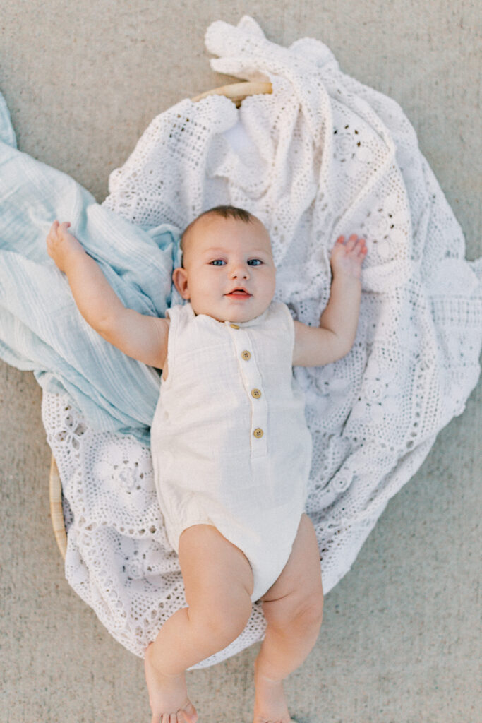 Baby smiling laying on a blanket at sunset session