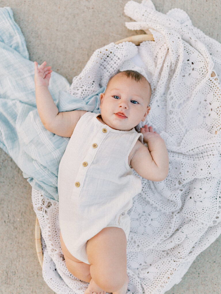 Baby laying in a basket at a sunset session